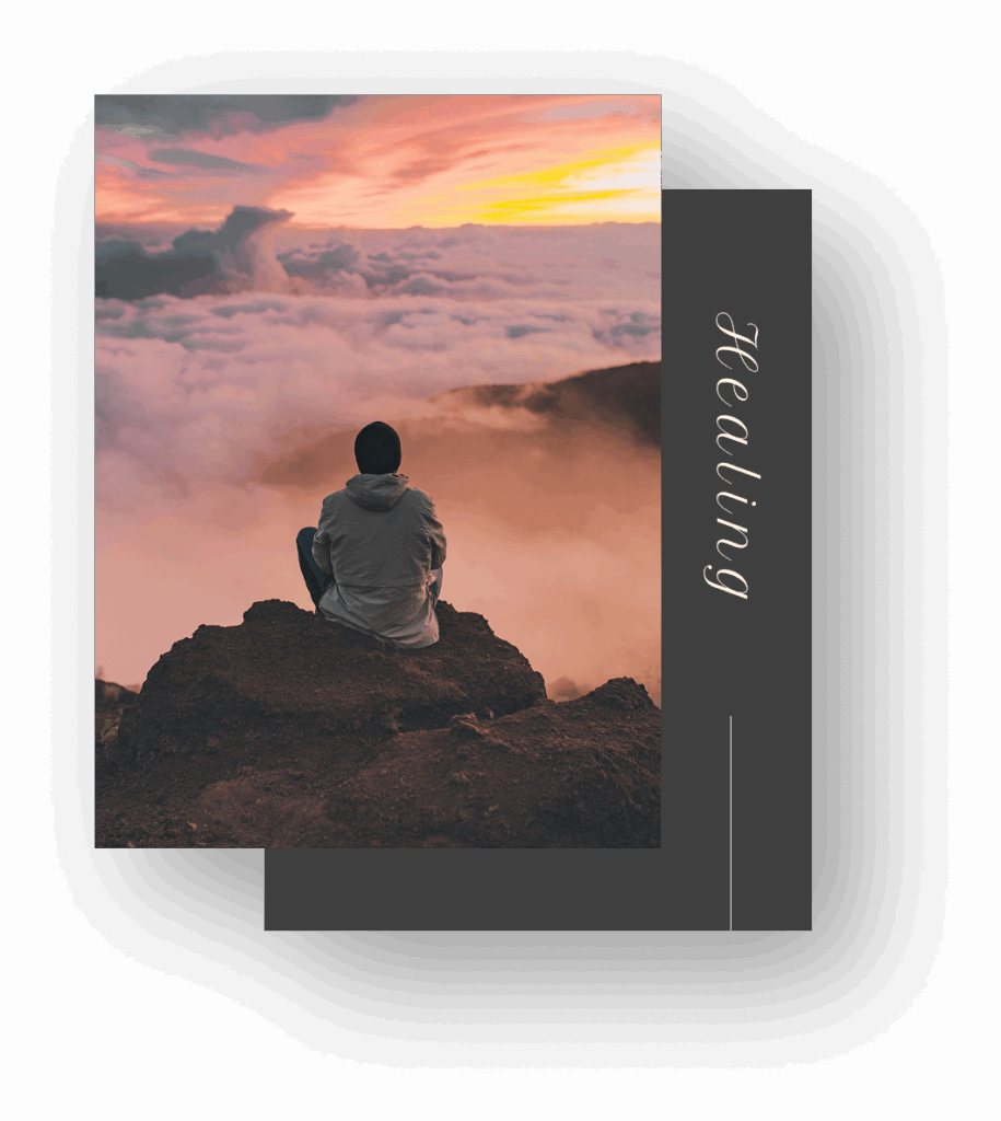 Person sitting on mountain at sunset above clouds