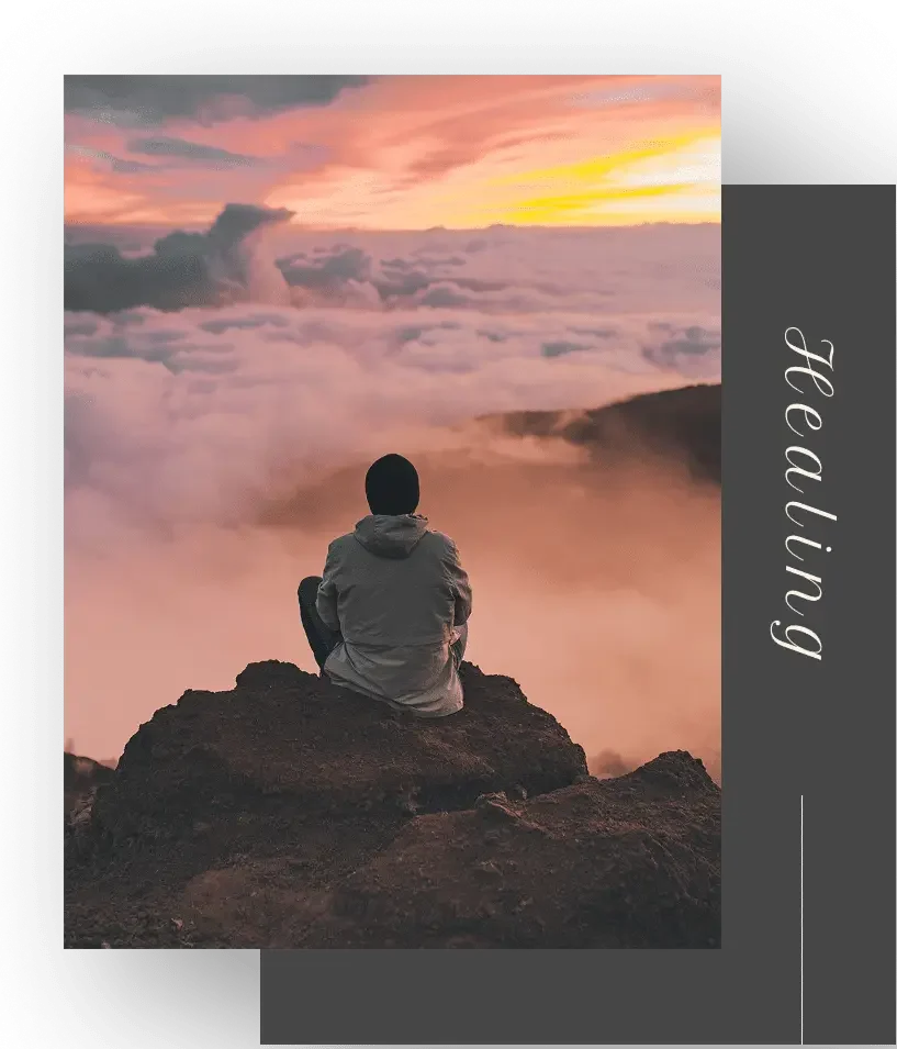 Person sitting on mountain at sunset above clouds